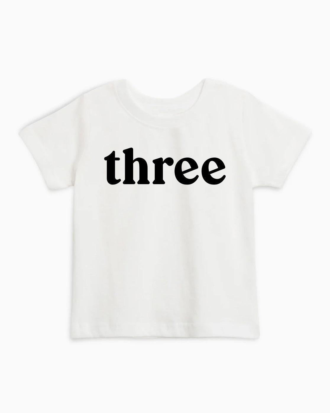 Kids organic cotton T-shirt in white with black 'three' text on front