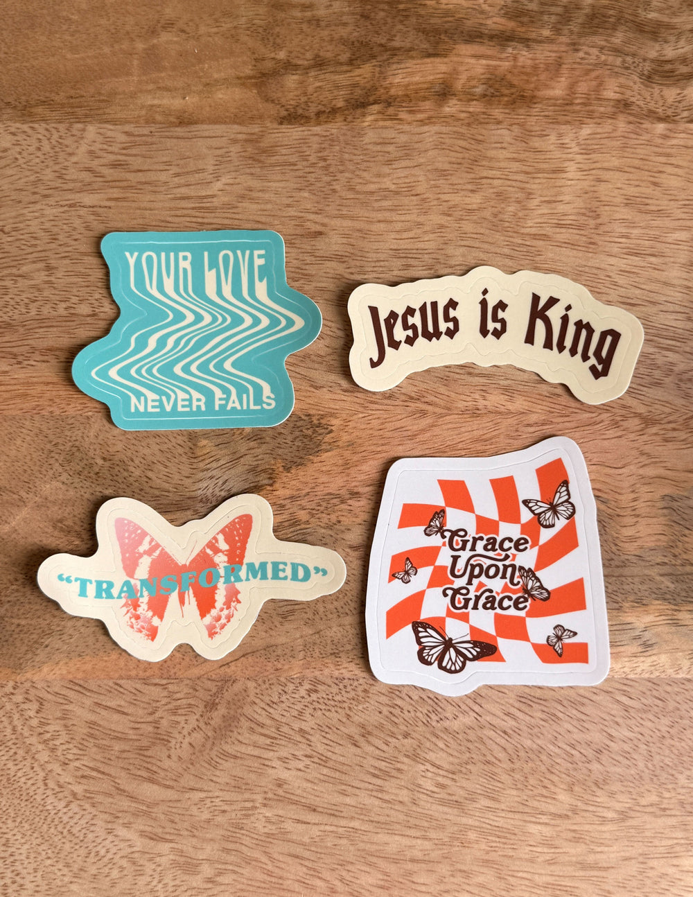 Sticker set on wood with Your Love Never Fails, Jesus is King, TRANSFORMED, Grace Upon Grace