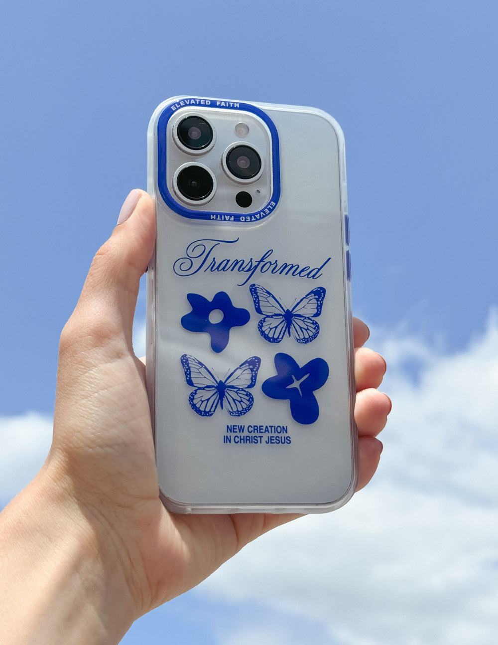 Clear phone case with blue butterflies and cross graphic, blue outline around camera