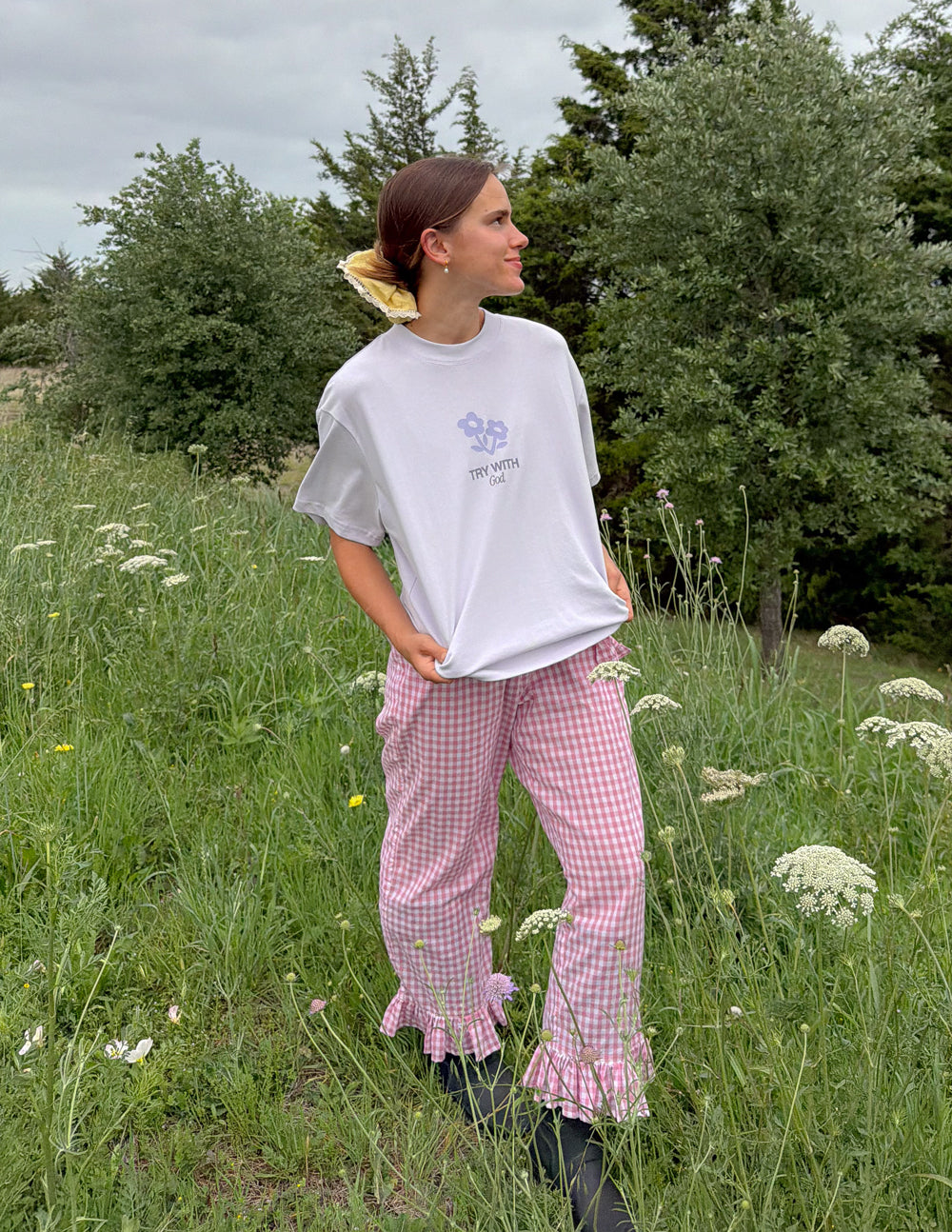 Light lavender unisex T-shirt with small chest flower icon and text, side view