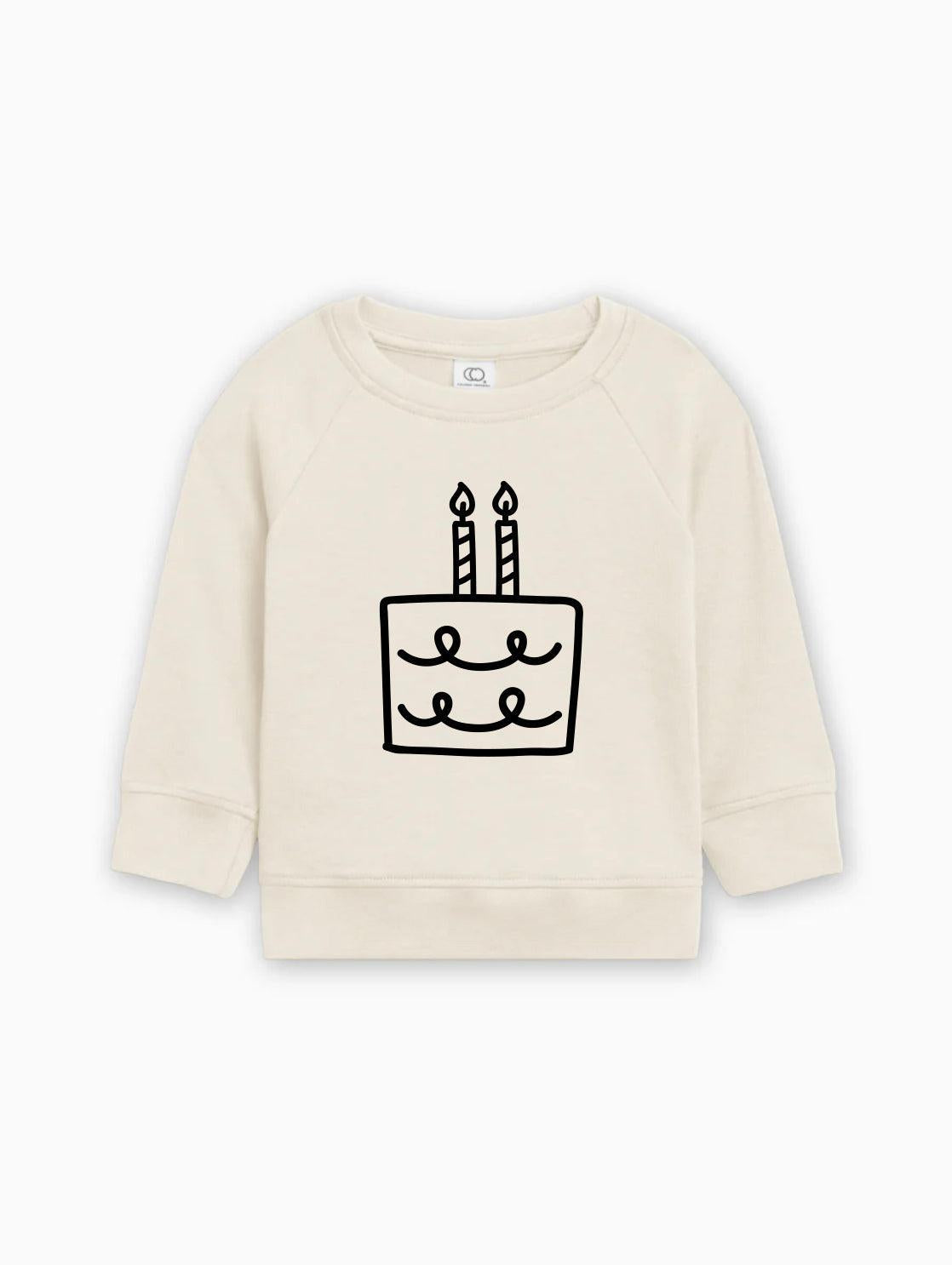 Cream baby pullover sweatshirt with birthday cake graphic on front