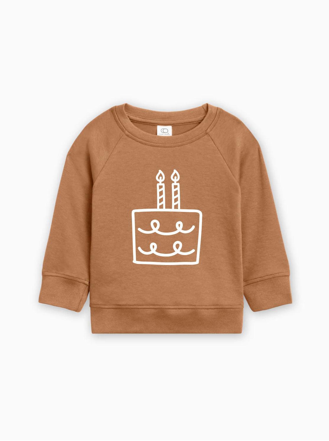 Tan baby pullover sweatshirt with birthday cake graphic on front