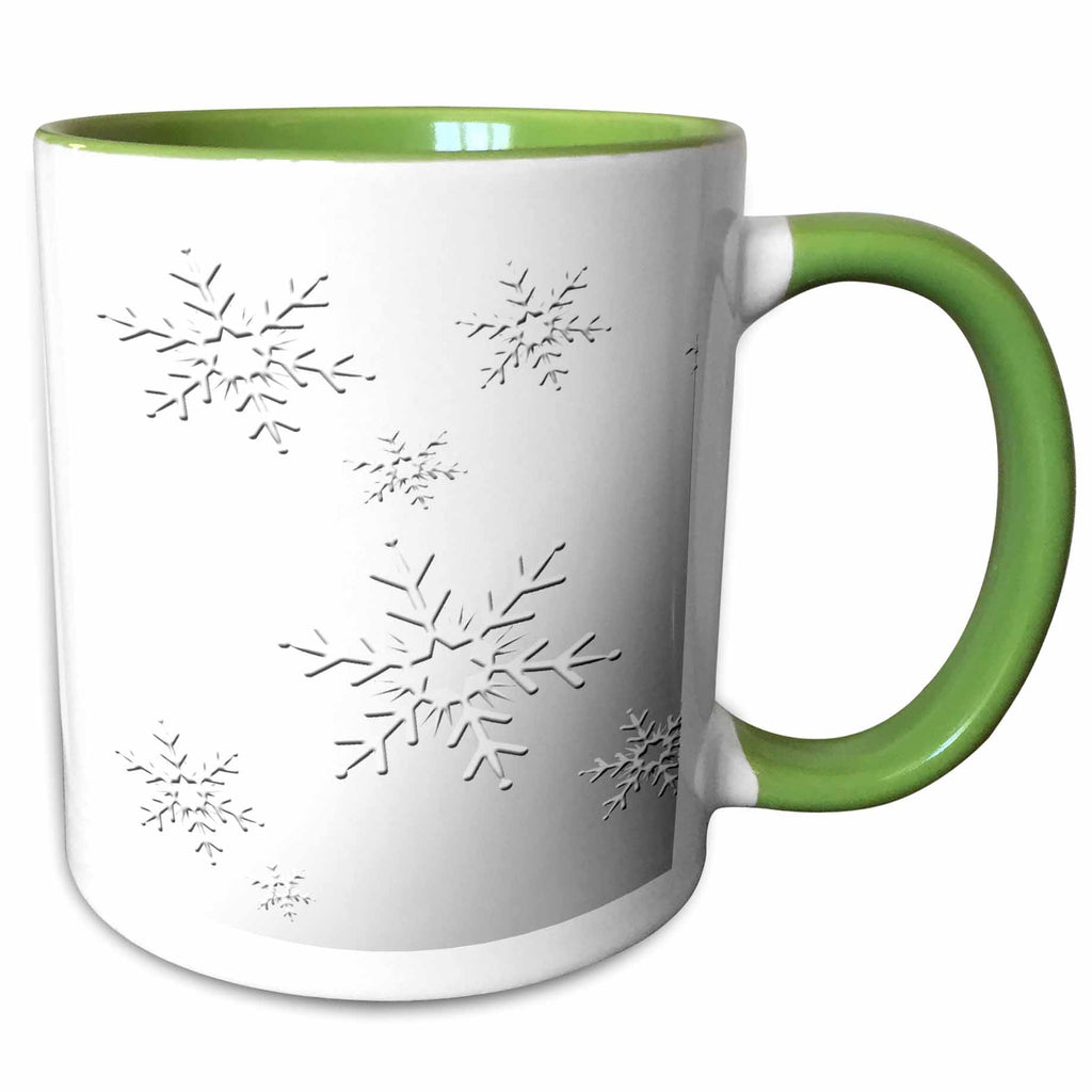 Two-tone mug with green rim and handle; white body with black snowflake design.