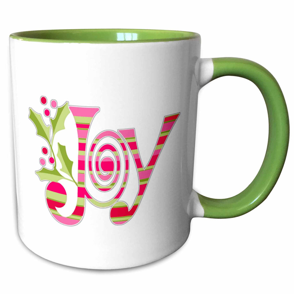 Two-tone ceramic mug with green interior and handle, featuring pink-and-green “Joy” design