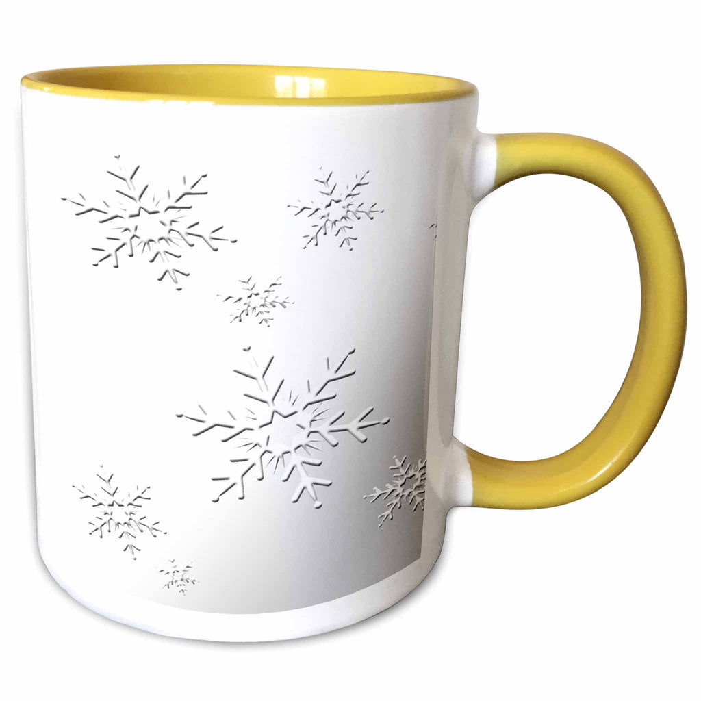 Two-tone yellow and white mug with black snowflake pattern and right-side handle