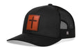 Black leather-look trucker hat with orange cross patch and mesh back