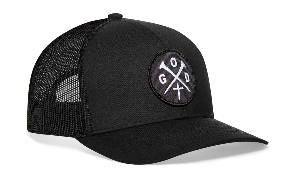 Black trucker snapback cap, curved brim, circular logo patch on front; side mesh panels