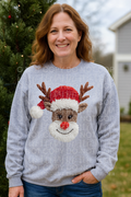 Faux yawn reindeer sweatshirt with front graphic of smiling brown reindeer and scarf