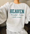Light gray crewneck sweatshirt with 'HEAVEN' graphic, 'Worship Team' text, and 'Jesus is King'