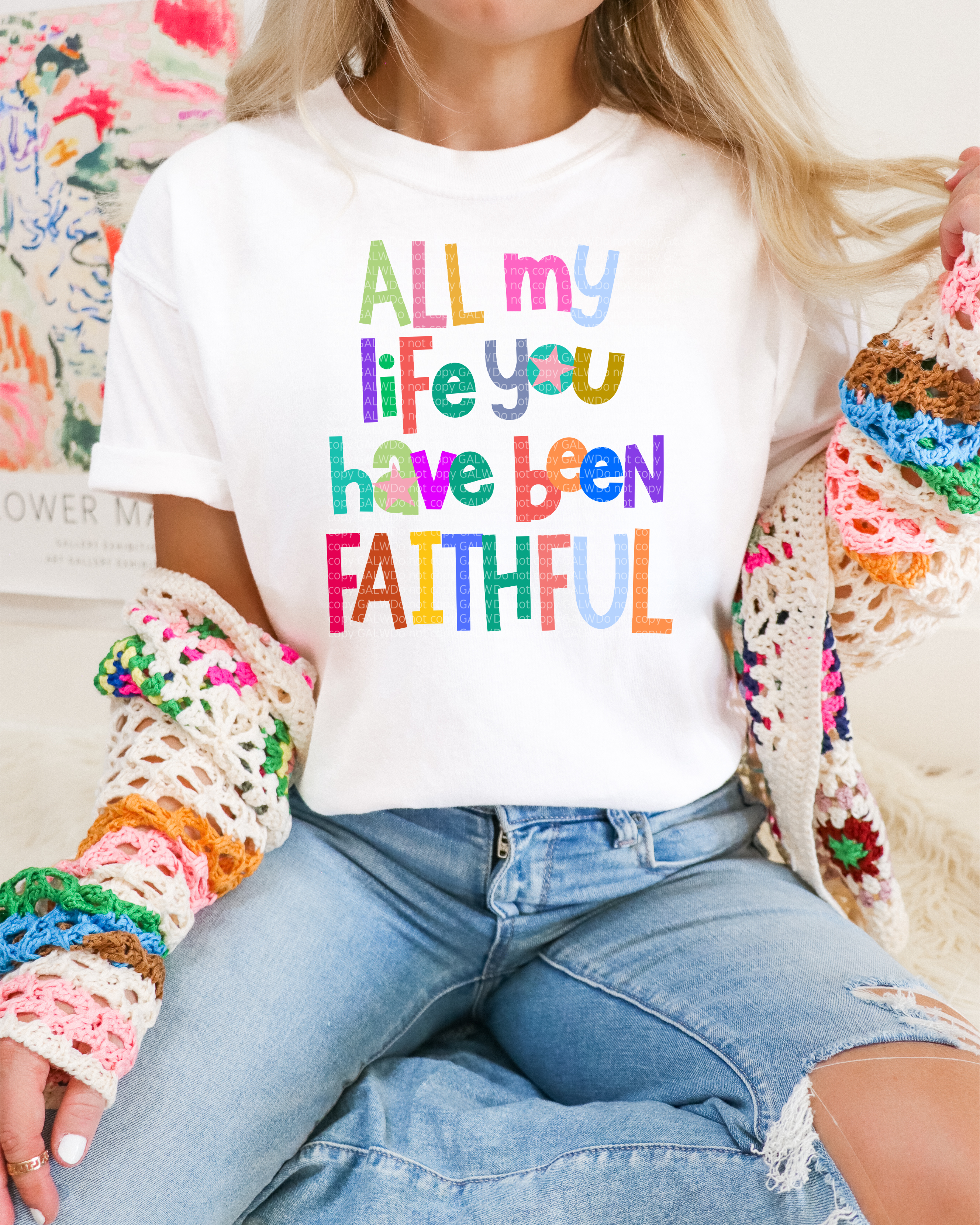 White T-shirt with multicolor lettering featuring faith quote