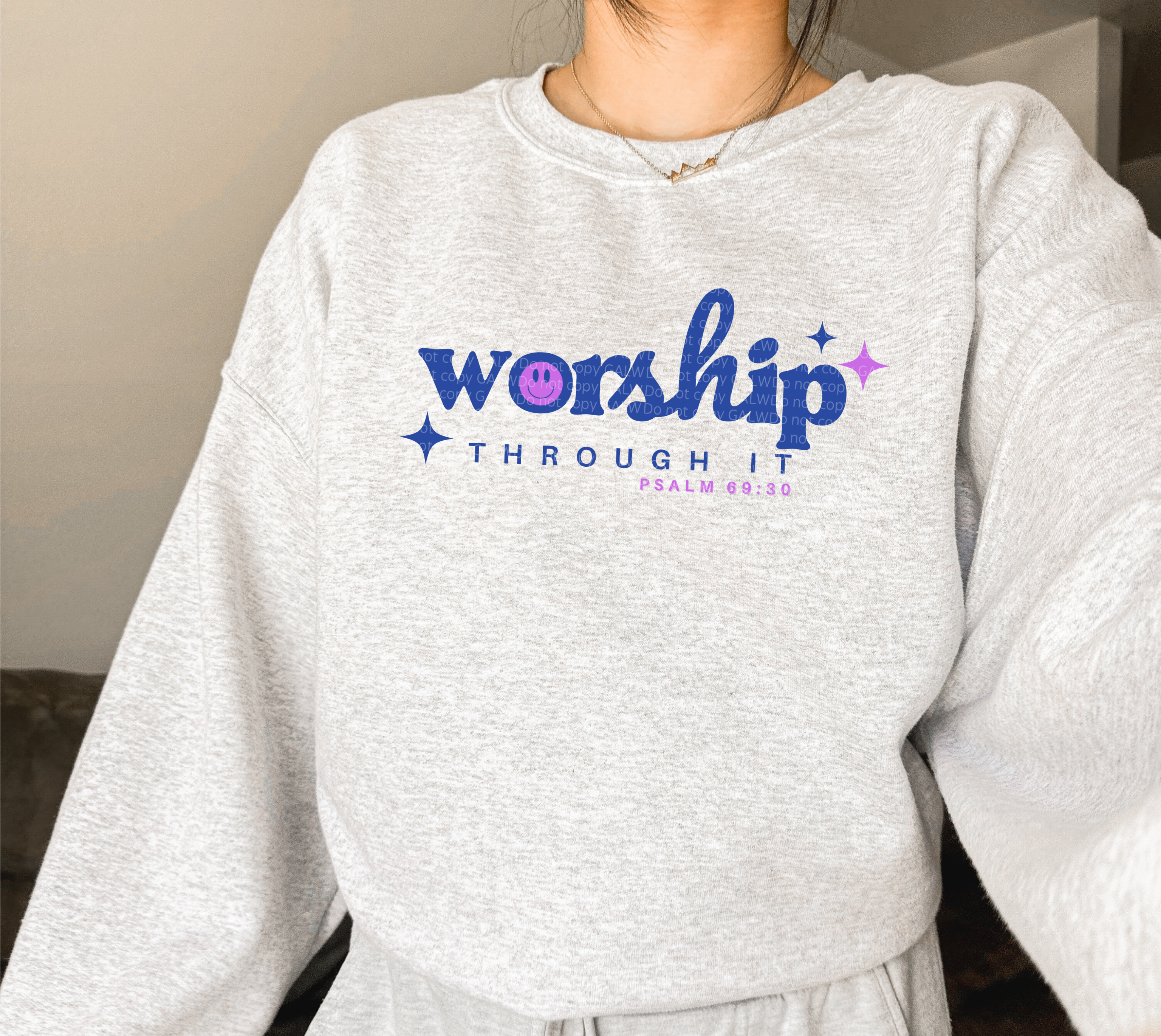 Heather gray sweatshirt with 'worship through it' star logo on front