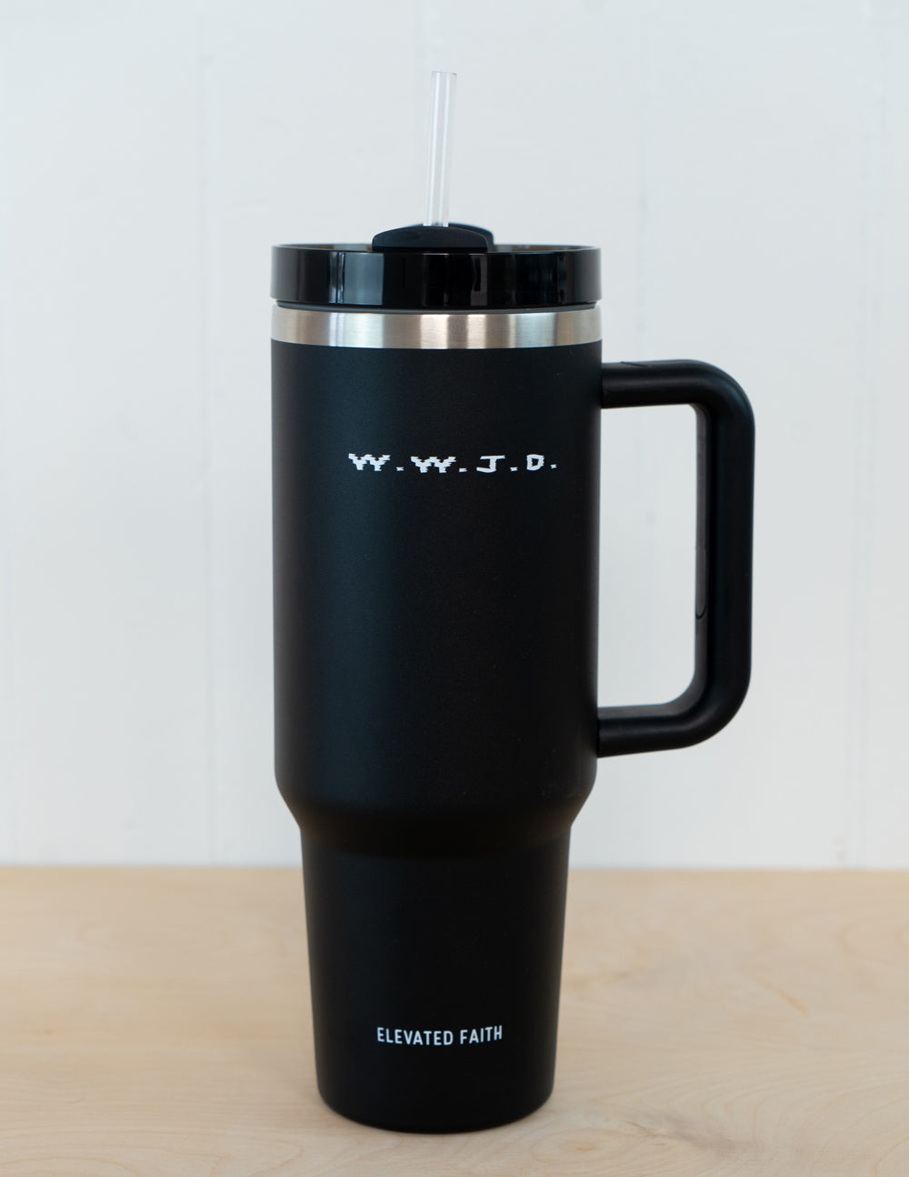 Black insulated tumbler with straw lid and side handle, shiny metal rim and WWJD logo.