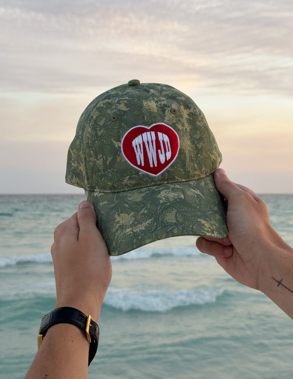 WWJD camo baseball cap with red heart logo patch, green camouflage pattern