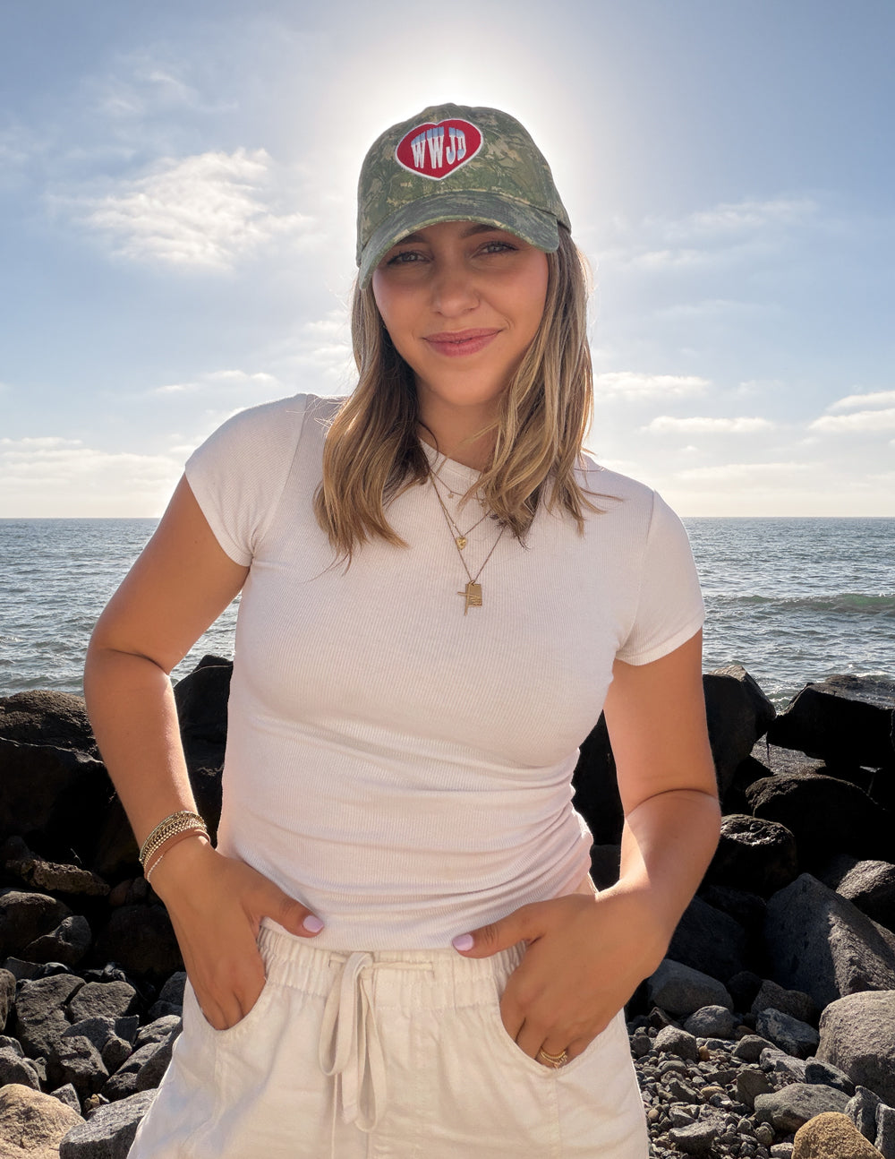 WWJD camo baseball cap with red heart logo patch, front and side view