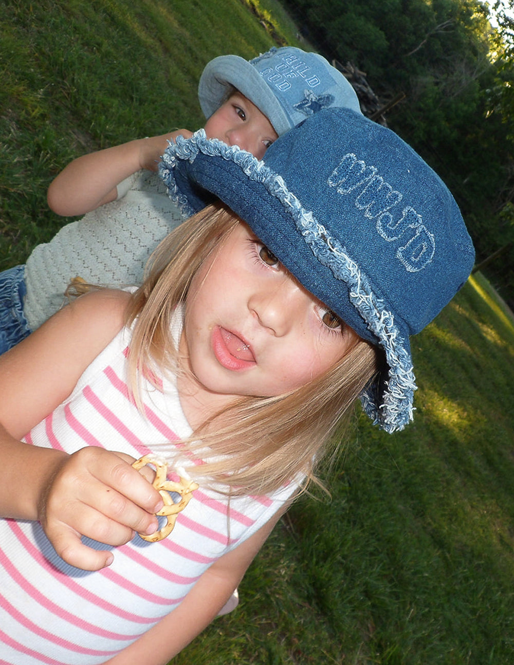 Denim bucket hat with embroidered lettering on side and frayed trim, blue