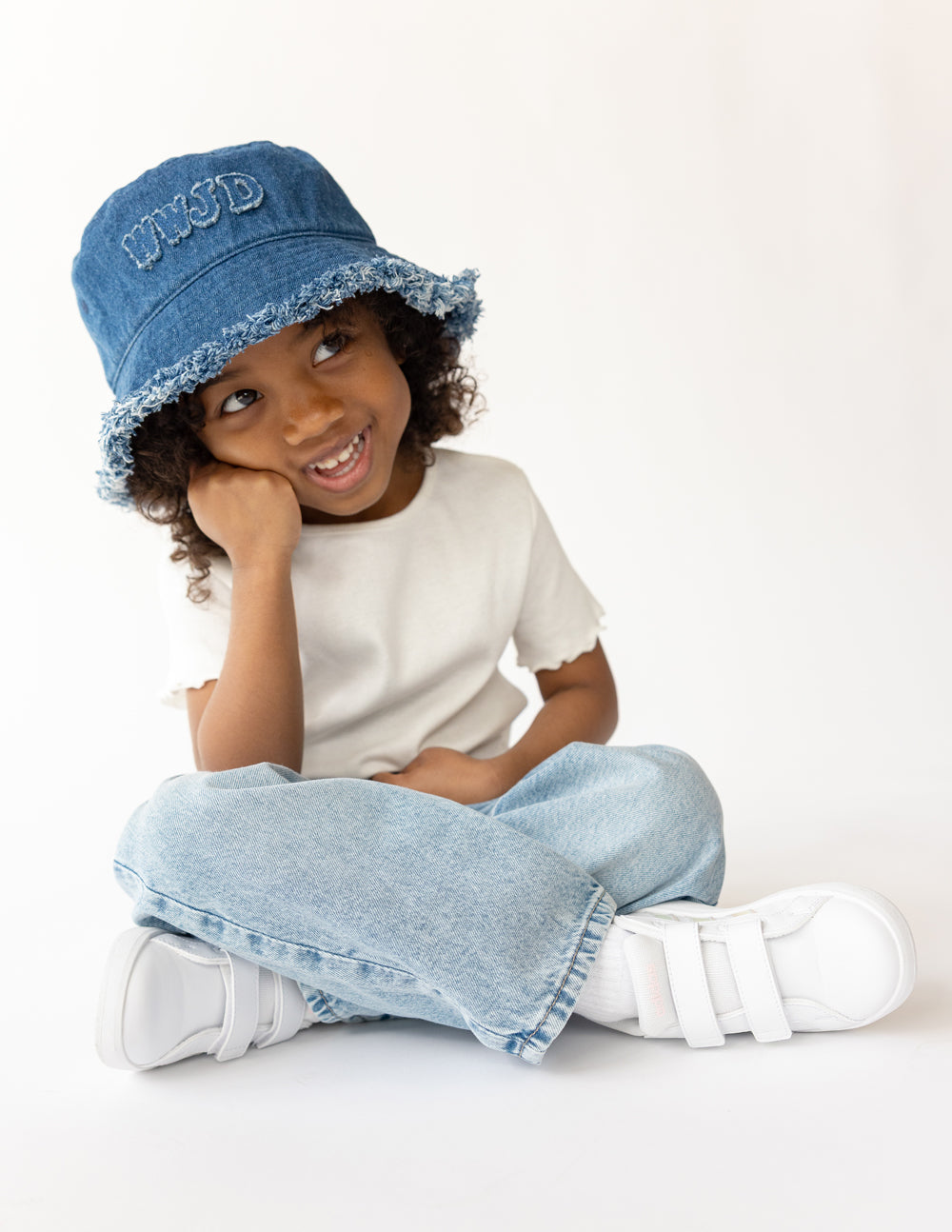 Denim bucket hat with embroidered WWJD logo and frayed bucket brim, blue