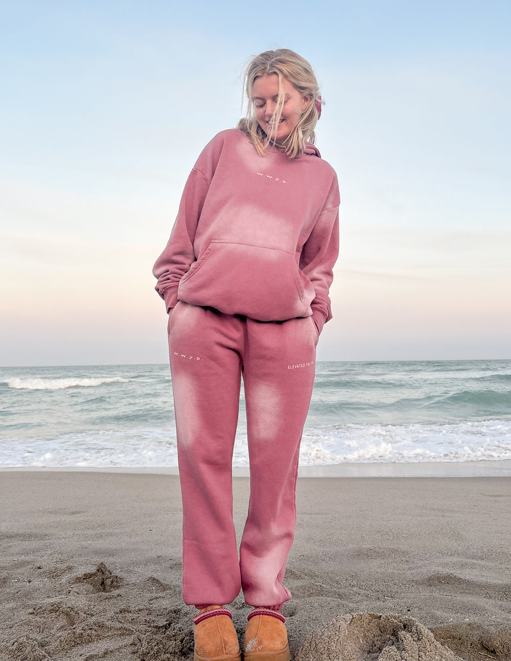 Pink sweatpants worn by model with relaxed straight leg