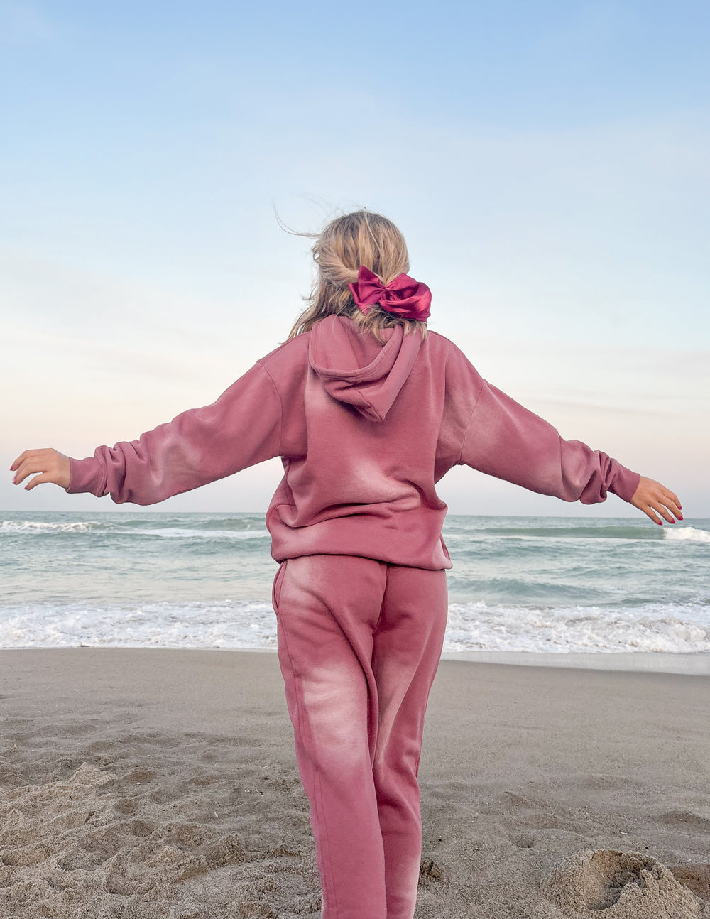 Pink sweatpants back view with elastic waist and cuffed hems