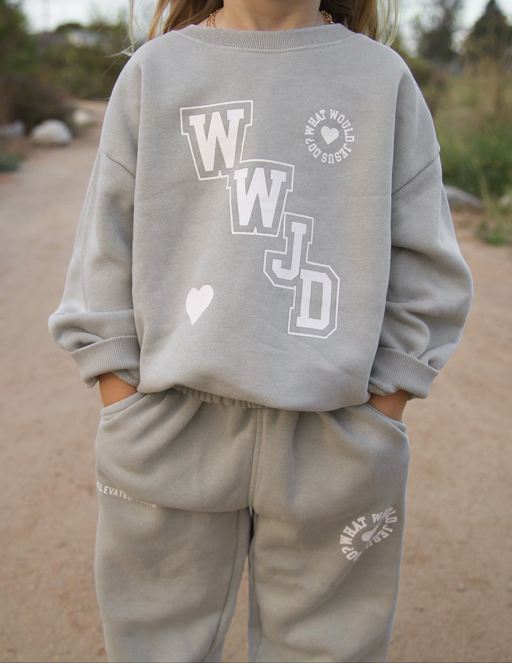 Kids varsity crewneck sweatshirt back view in light gray with large WJD logo