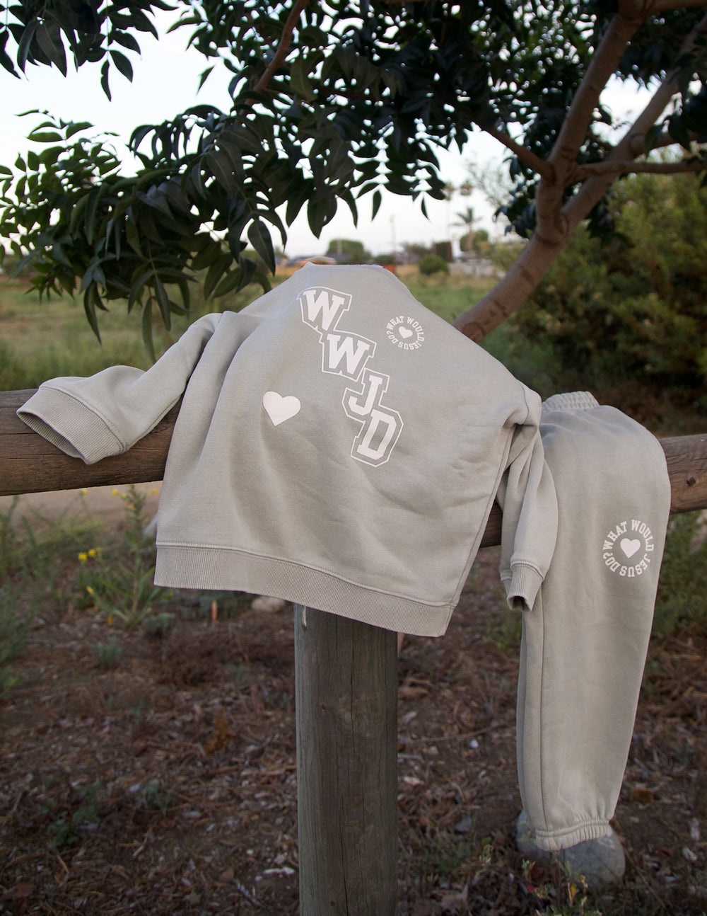 Kids varsity crewneck sweatshirt back view in light gray with WJD and heart details