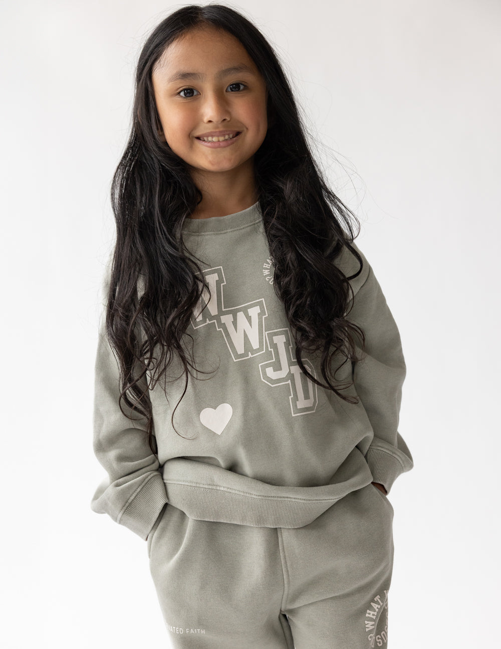 Kids varsity crewneck sweatshirt in light gray with WJD graphic and heart on chest