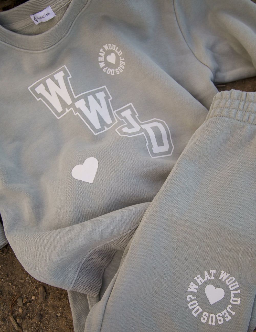 Light gray kids sweatpants with heart logo on thigh and woven cuff detail