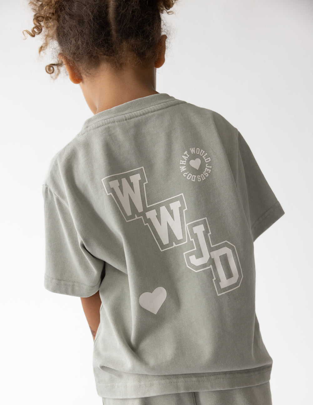 Kids varsity tee in heather gray, short sleeves, back graphic with hearts and logo