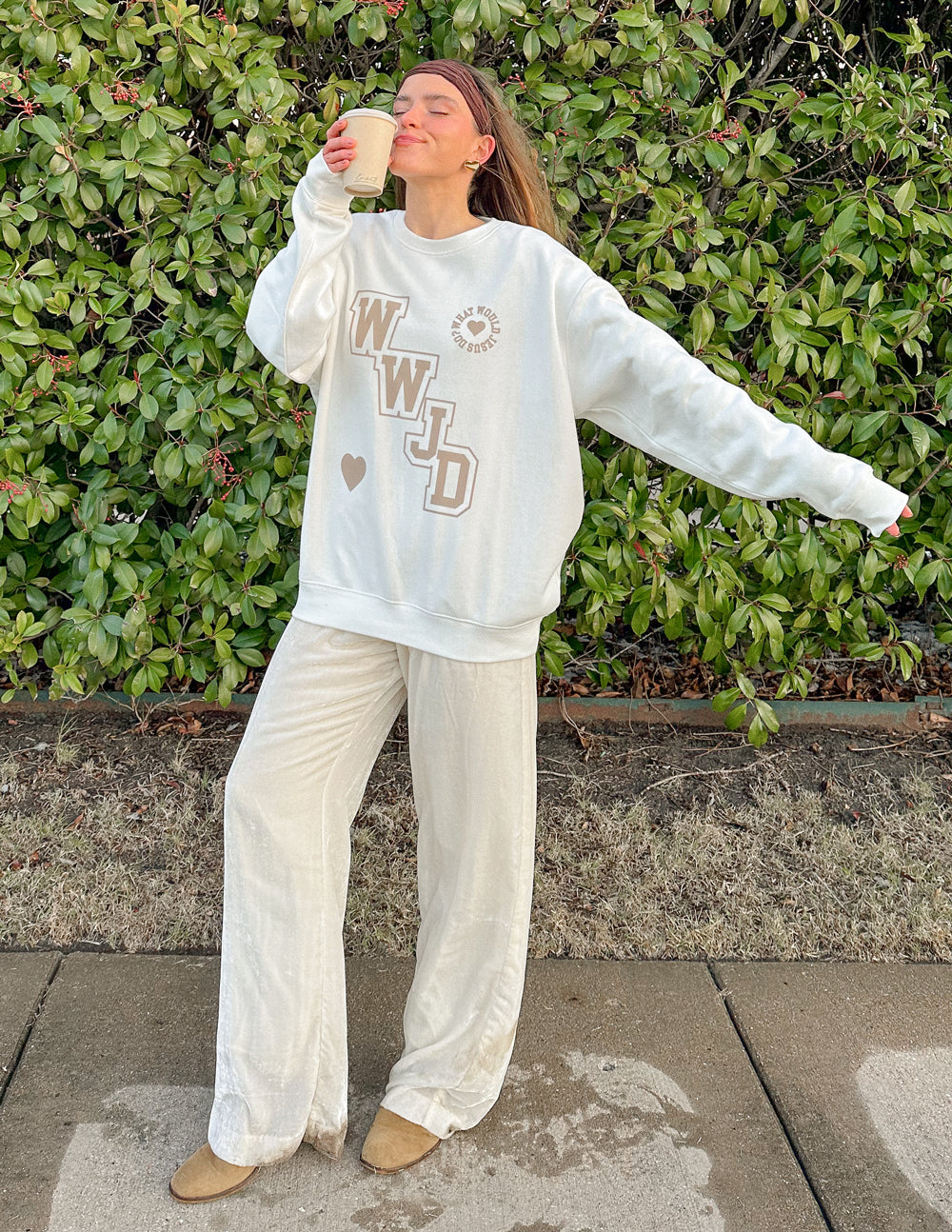 Off-white unisex crewneck sweatshirt with WWJD varsity print and heart detail