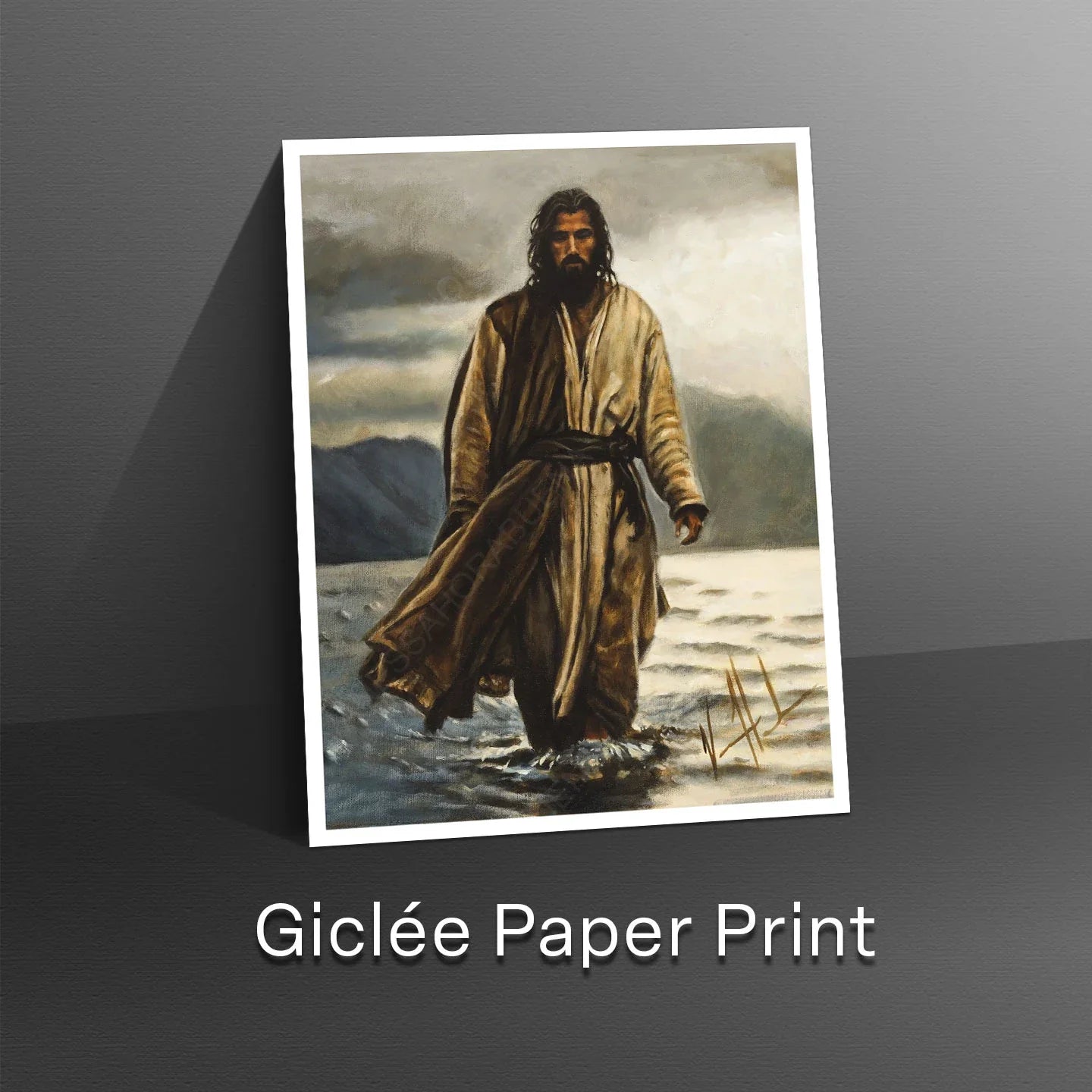 White-bordered wall art print showing a robed man walking in a desert landscape