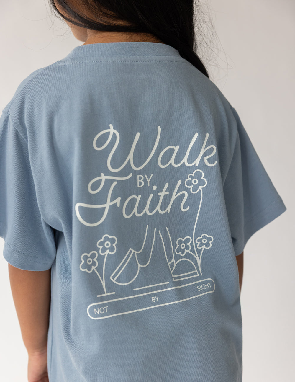 Light blue kids T-shirt with detailed back "Walk by Faith" script and book graphic