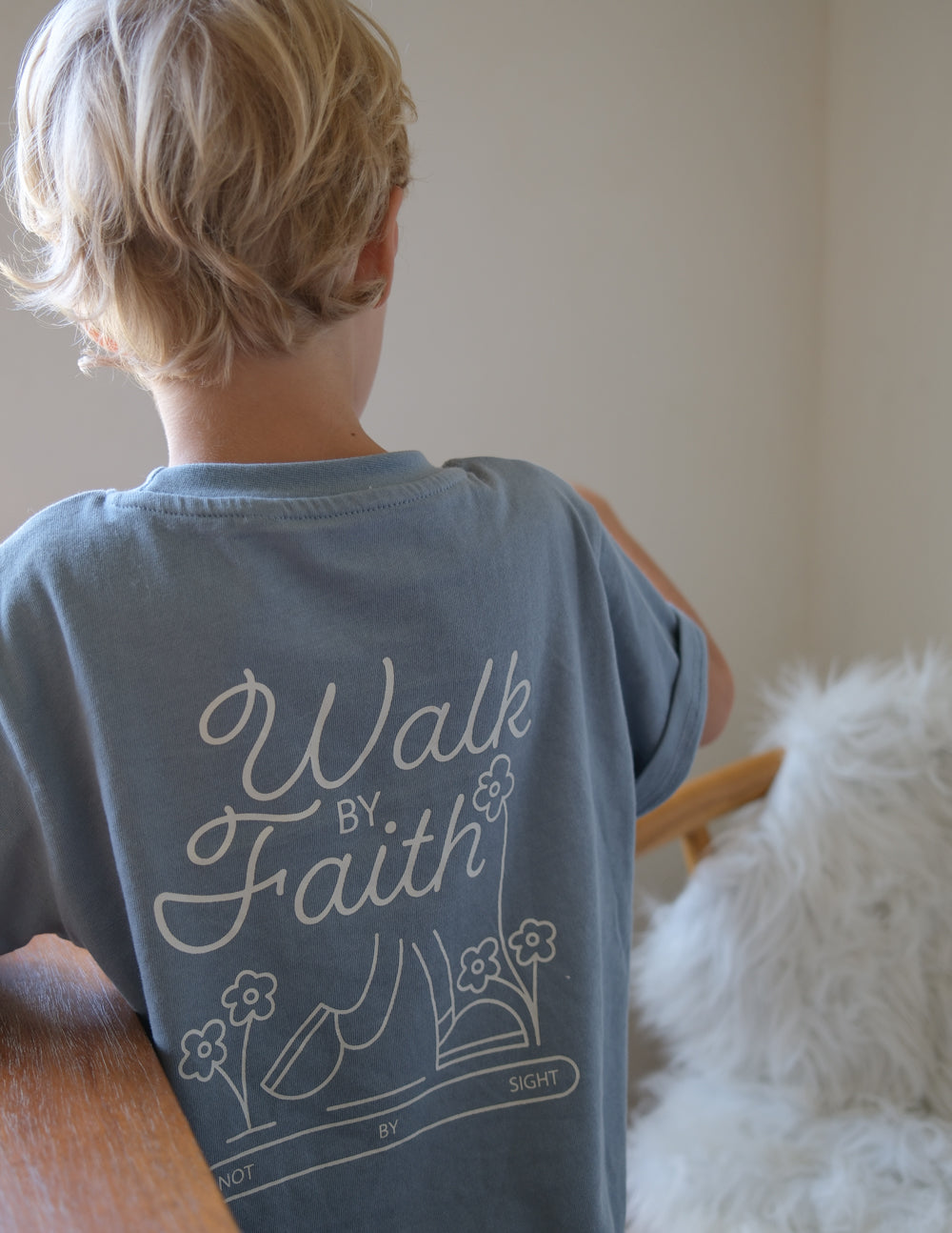 Light blue kids T-shirt with back "Walk by Faith" script and floral book graphic