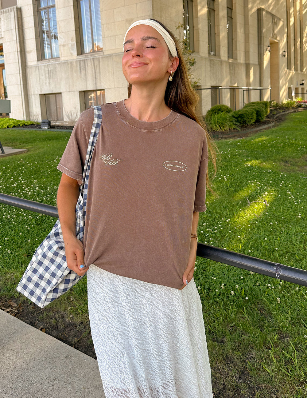 Brown unisex crewneck tee with 'Walk by Faith' text and oval '2 Corinthians 5:7'.