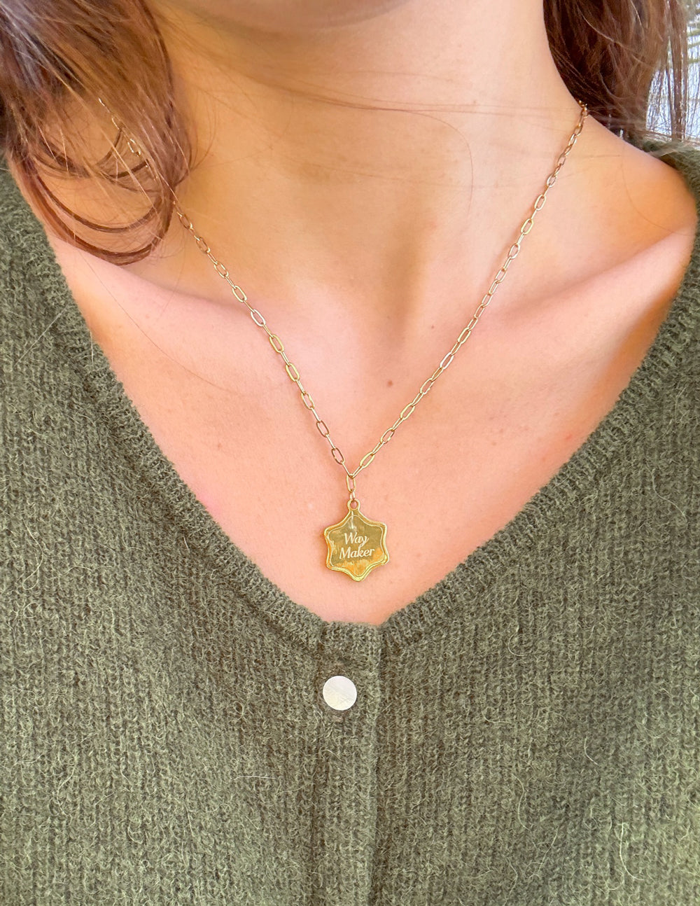 Way Maker necklace with gold-tone chain and engraved shield pendant at neckline