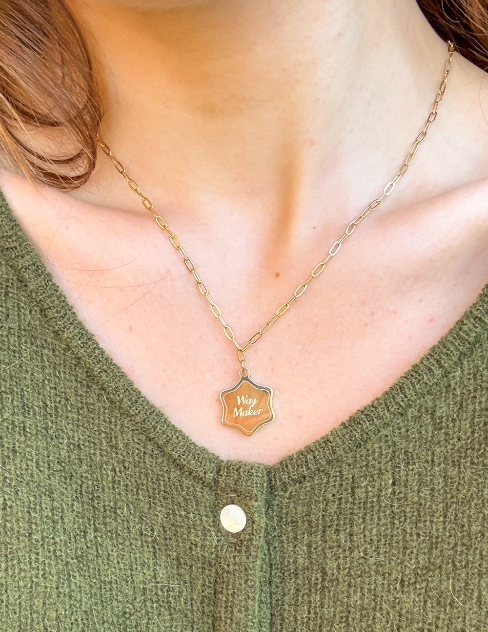 Way Maker necklace with gold-tone chain and small engraved shield pendant at chest