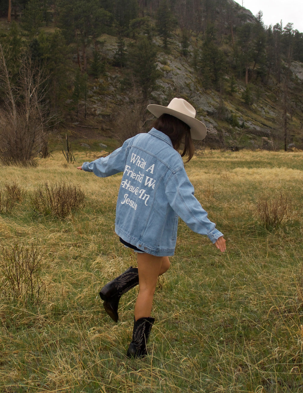 Light-wash denim jacket with back graphic text and button-front closure