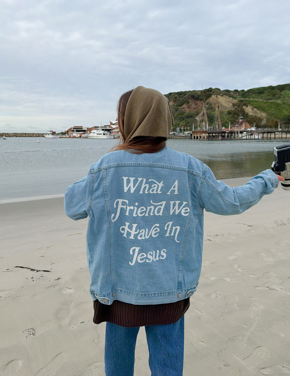 Light-wash denim jacket with back graphic text and relaxed fit