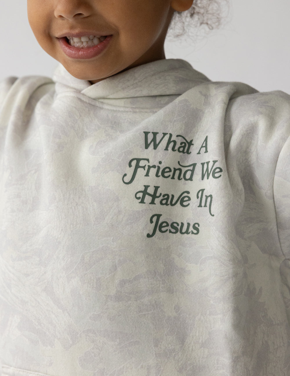 Kids hoodie in light gray, close-up of chest graphic “What A Friend We Have In Jesus”.