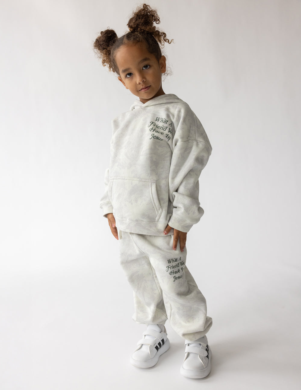 Kids pullover hoodie set in light gray with front pocket and small back graphic text.