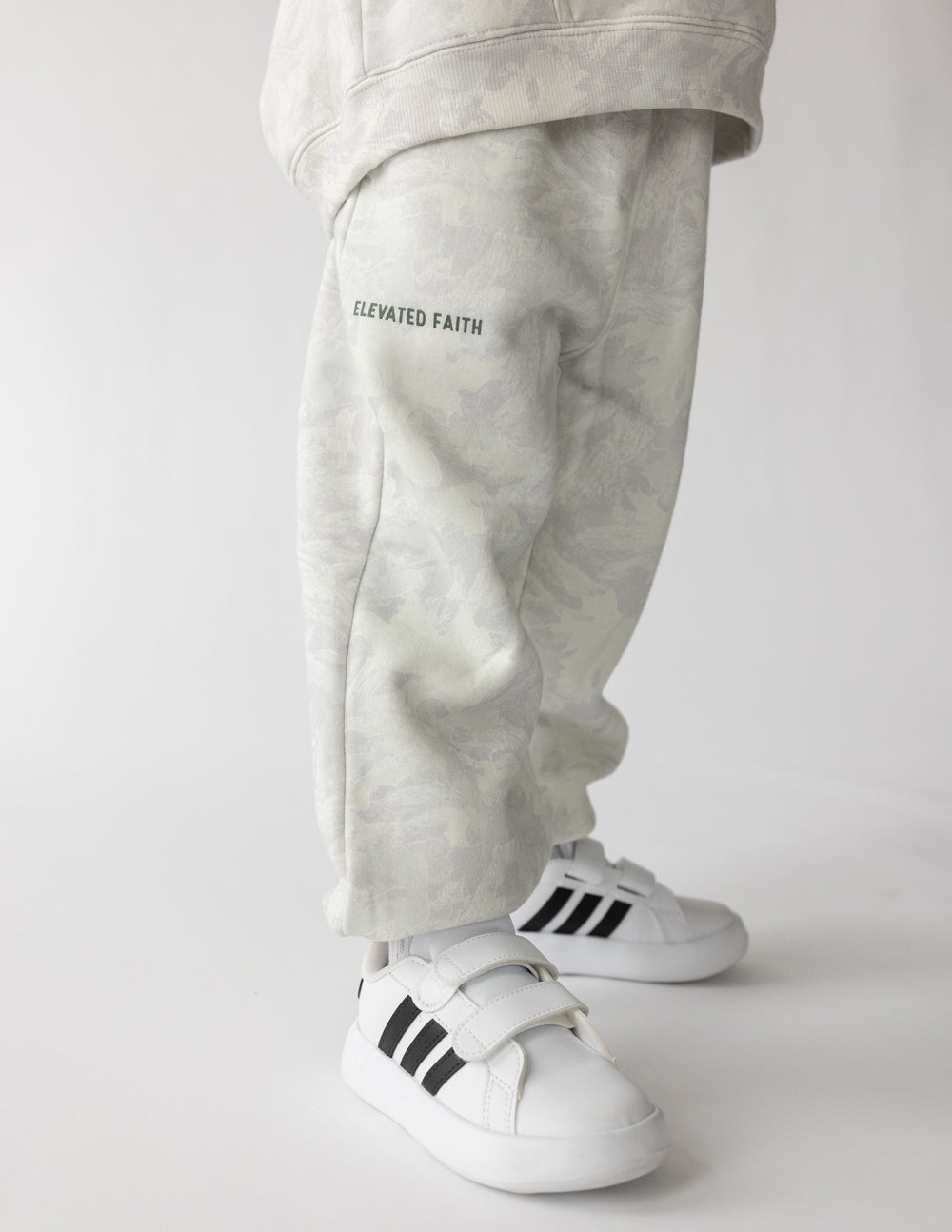 Kids sweatpants with side logo text print and tapered leg, elastic cuffs