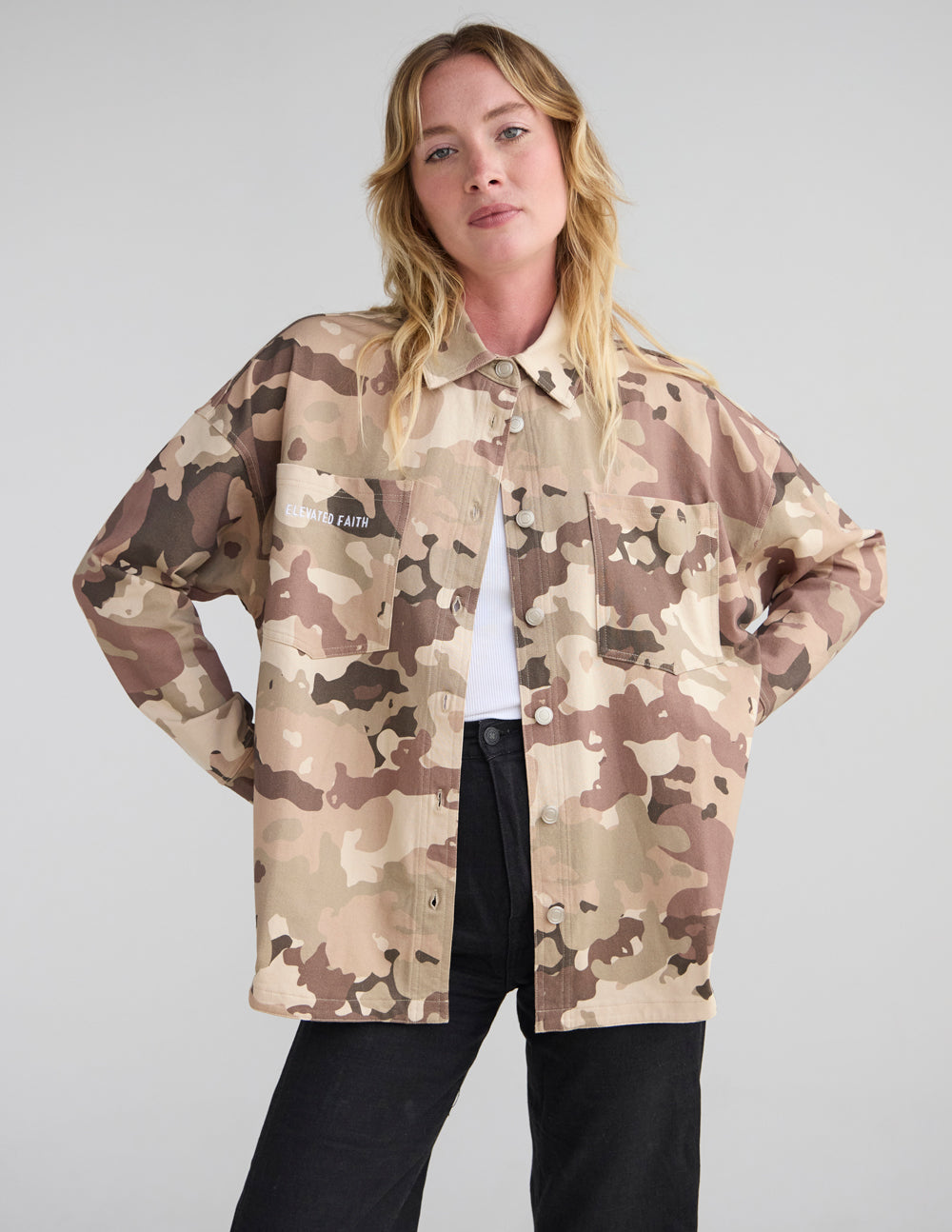 Camouflage shacket jacket with button-front and two chest pockets.