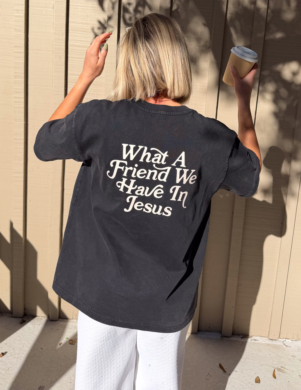 Black heavyweight T-shirt with large back text "What A Friend We Have In Jesus"