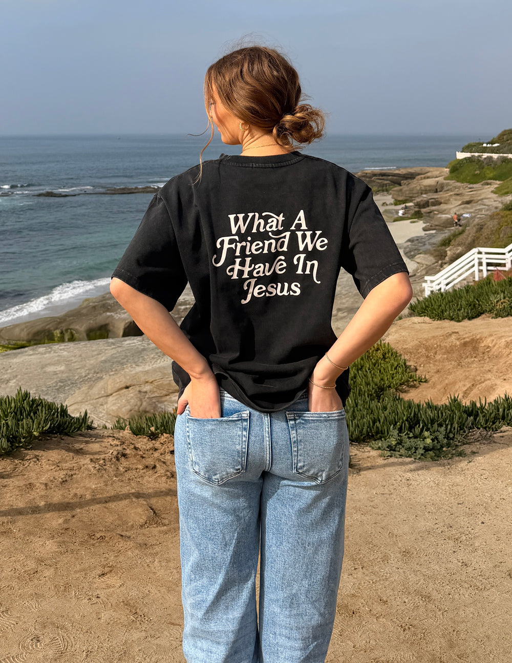 Black heavyweight T-shirt with large back text "What A Friend We Have In Jesus"
