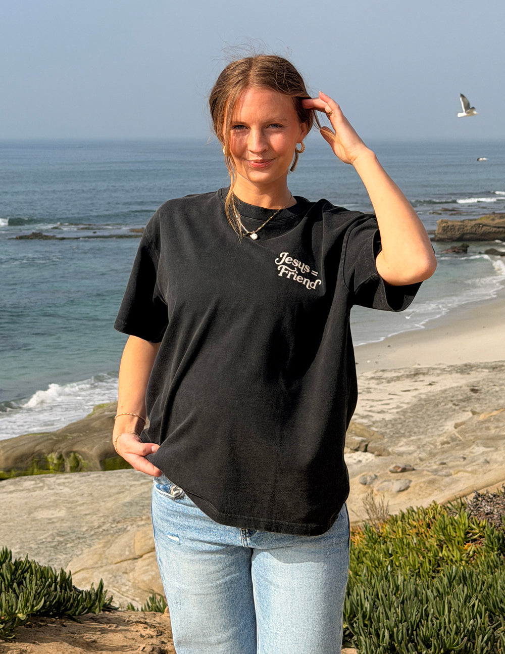Black heavyweight T-shirt with small chest graphic "Jesus Friend" and crew neckline