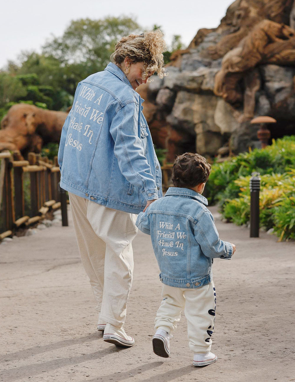 Kids light-wash denim jacket with back inspirational text print mentioning Jesus
