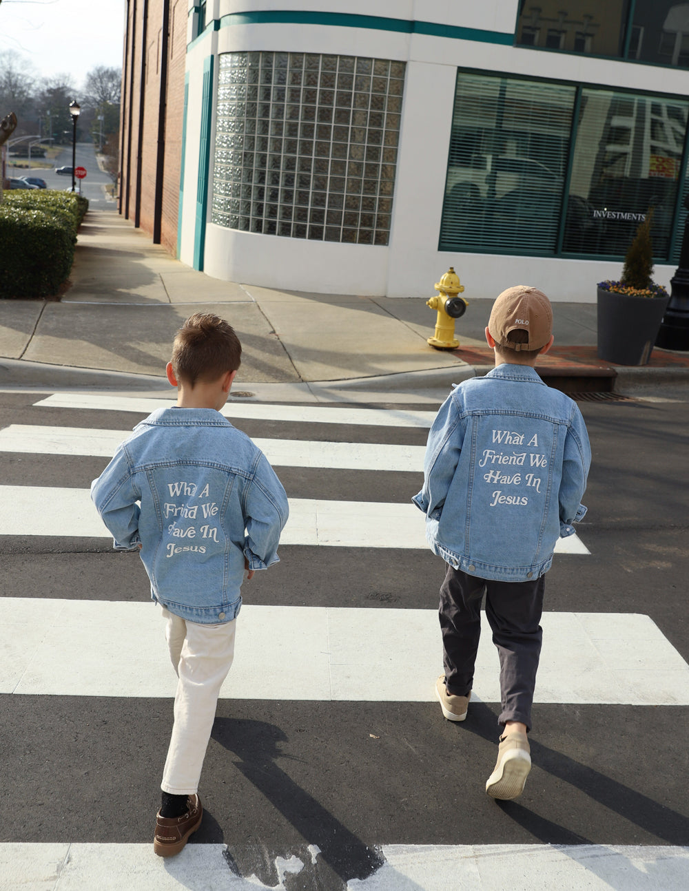Kids light-wash denim jackets with back inspirational text print mentioning Jesus
