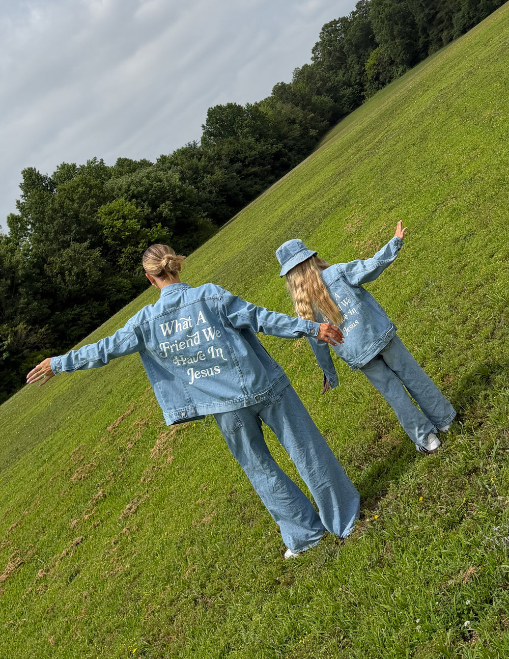 Kids light-wash denim jacket with back inspirational text print mentioning Jesus