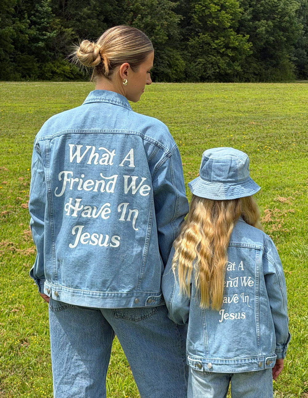 Kids light-wash denim jackets showing back inspirational text print mentioning Jesus