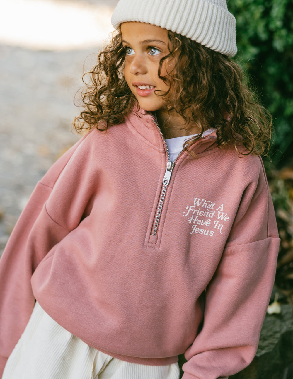 Kids mauve half-zip sweatshirt, front embroidery and quarter-zip placket visible