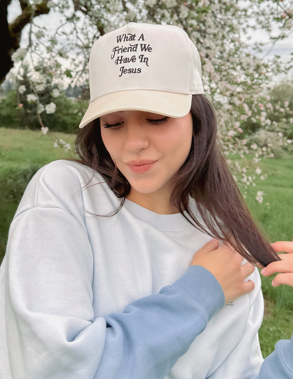Cream-white baseball cap with embroidered “What a Friend We Have In Jesus” on front