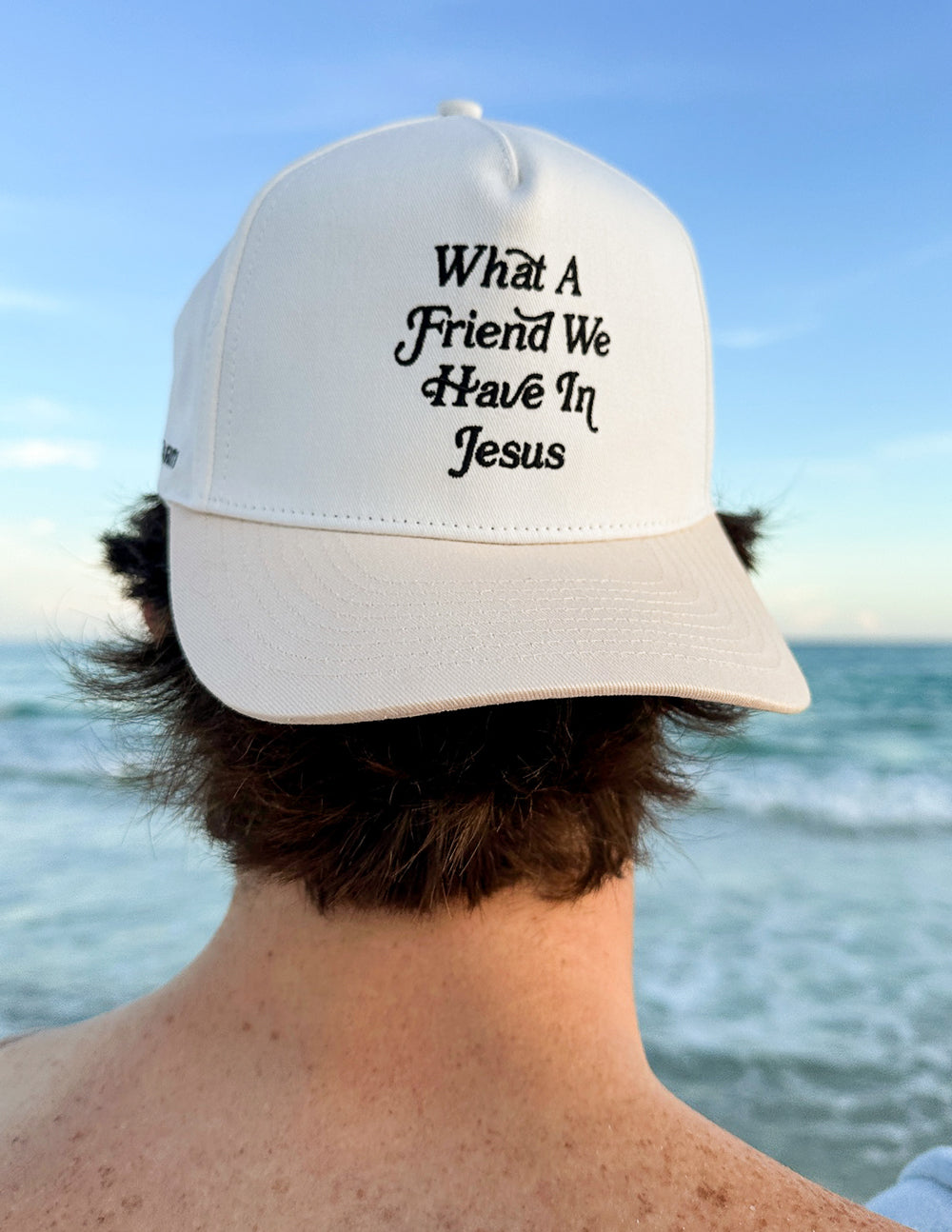 White cap viewed from the side with “What a Friend We Have In Jesus” front text